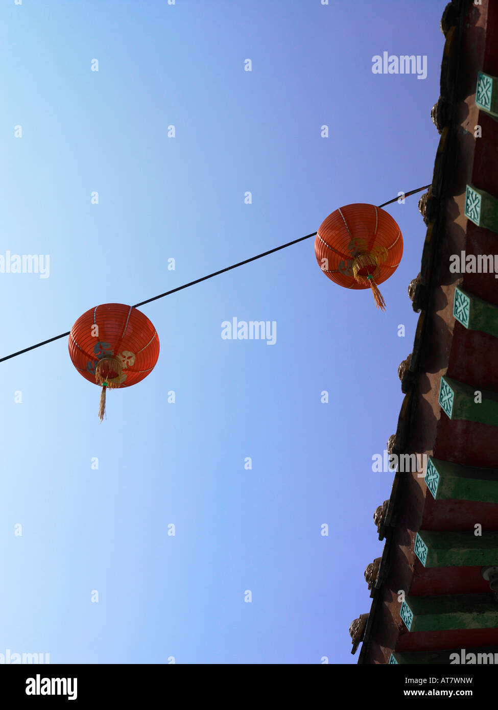 2 red lanterns hanging from the roof of temple Stock Photo - Alamy