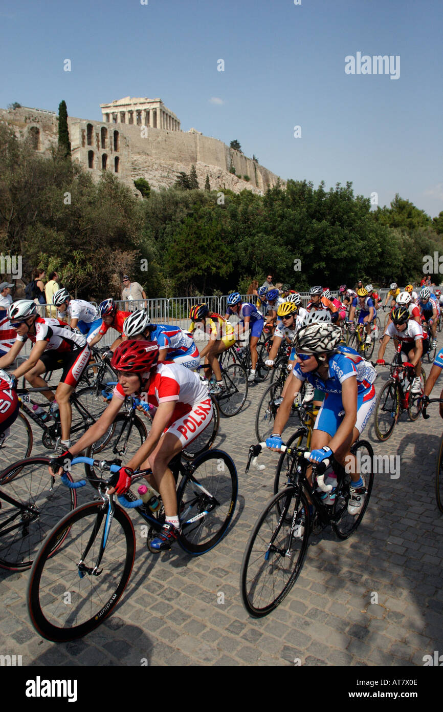 The womens peloton sweeps round a corner on the cobbled streets under