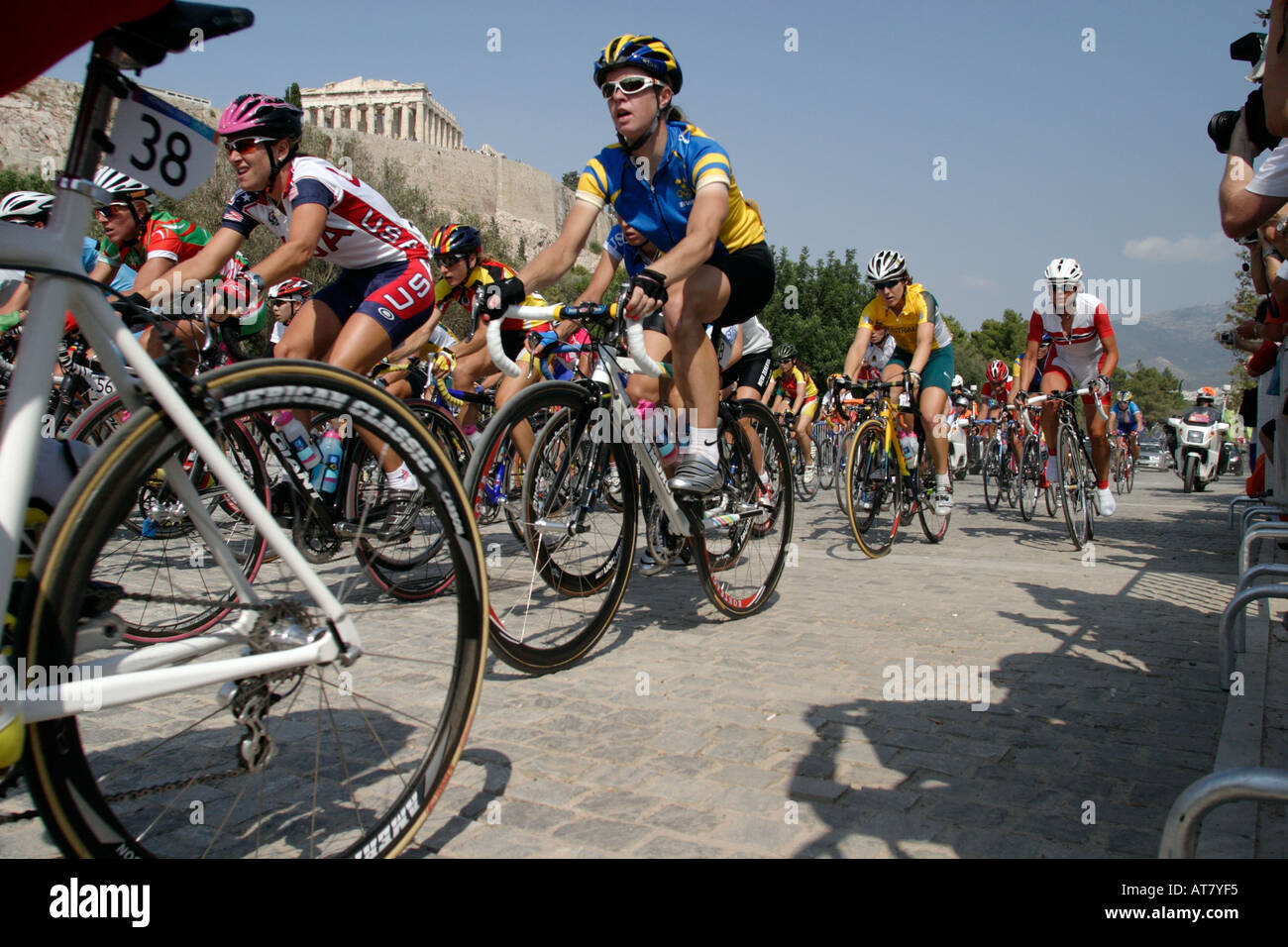 The womens peloton sweeps up the cobbled streets under the Acropolis