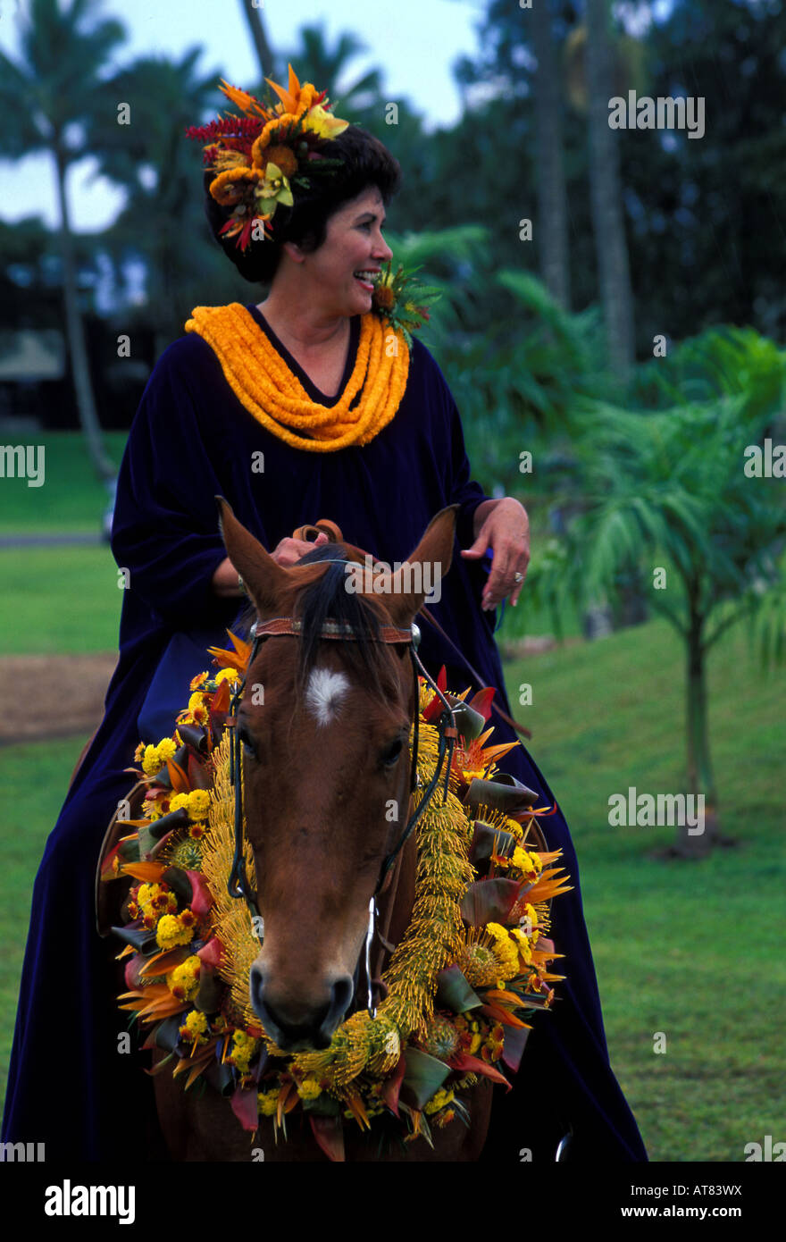 Woman riding horse (pau rider) with leis at Merrie Monarch festival parade Stock Photo