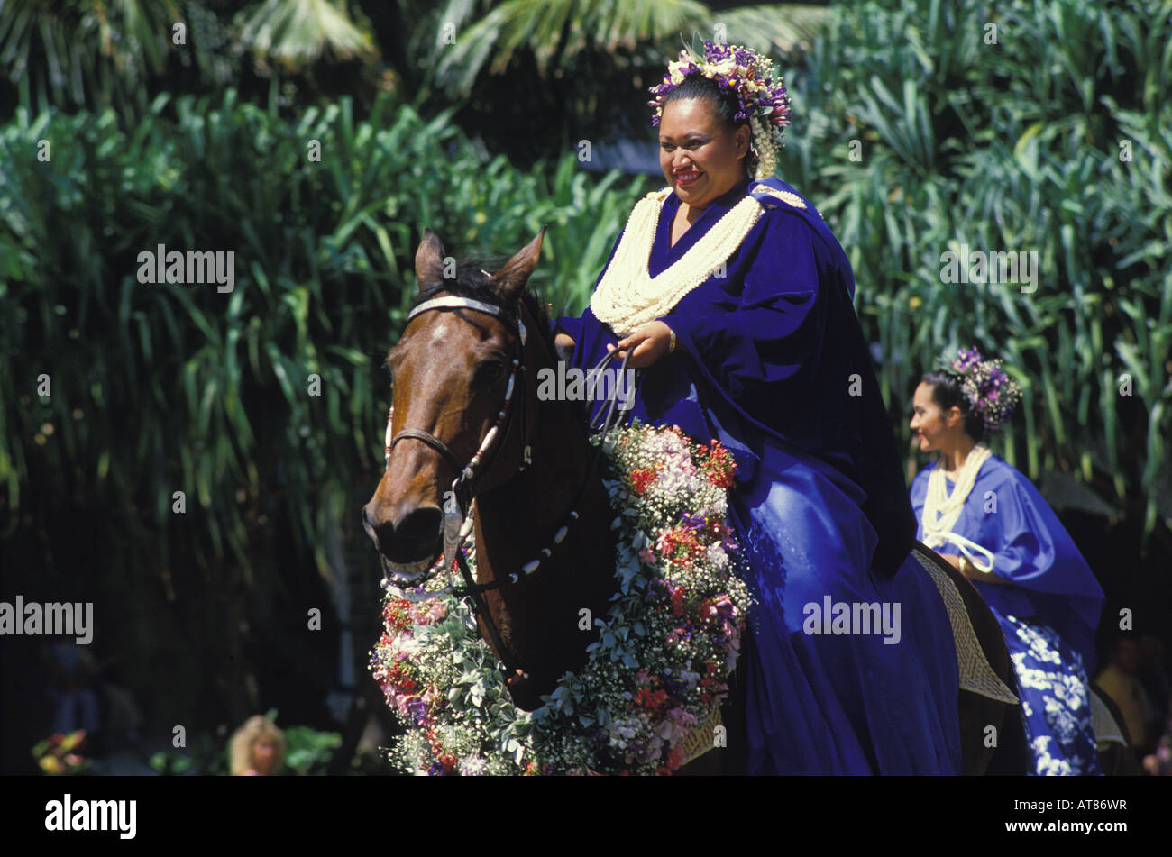 Pa'u rider in the annual Aloha Festivals Parade rides a floral-bedecked horse. Her attire is one continuous piece of fabric, Stock Photo