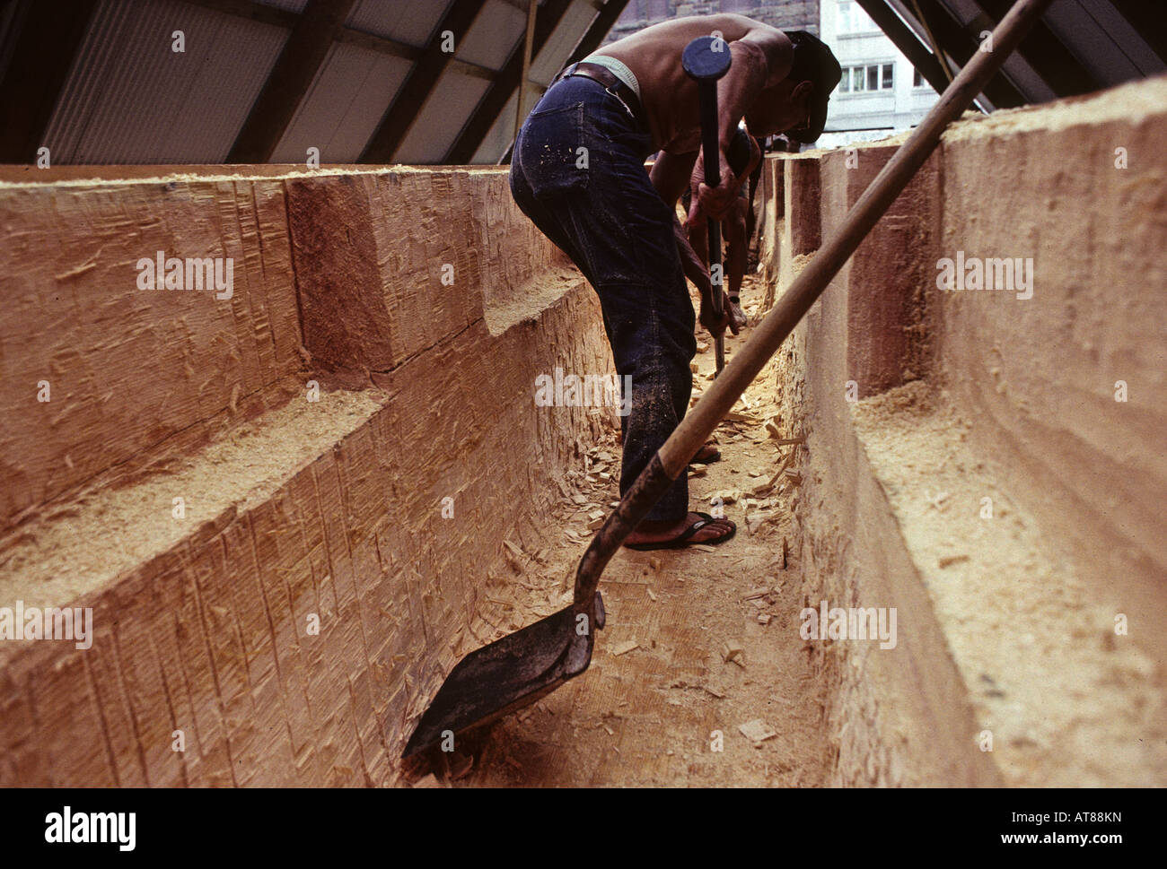Building Polynesian voyaging canoe, Hawaiiloa carving out hull