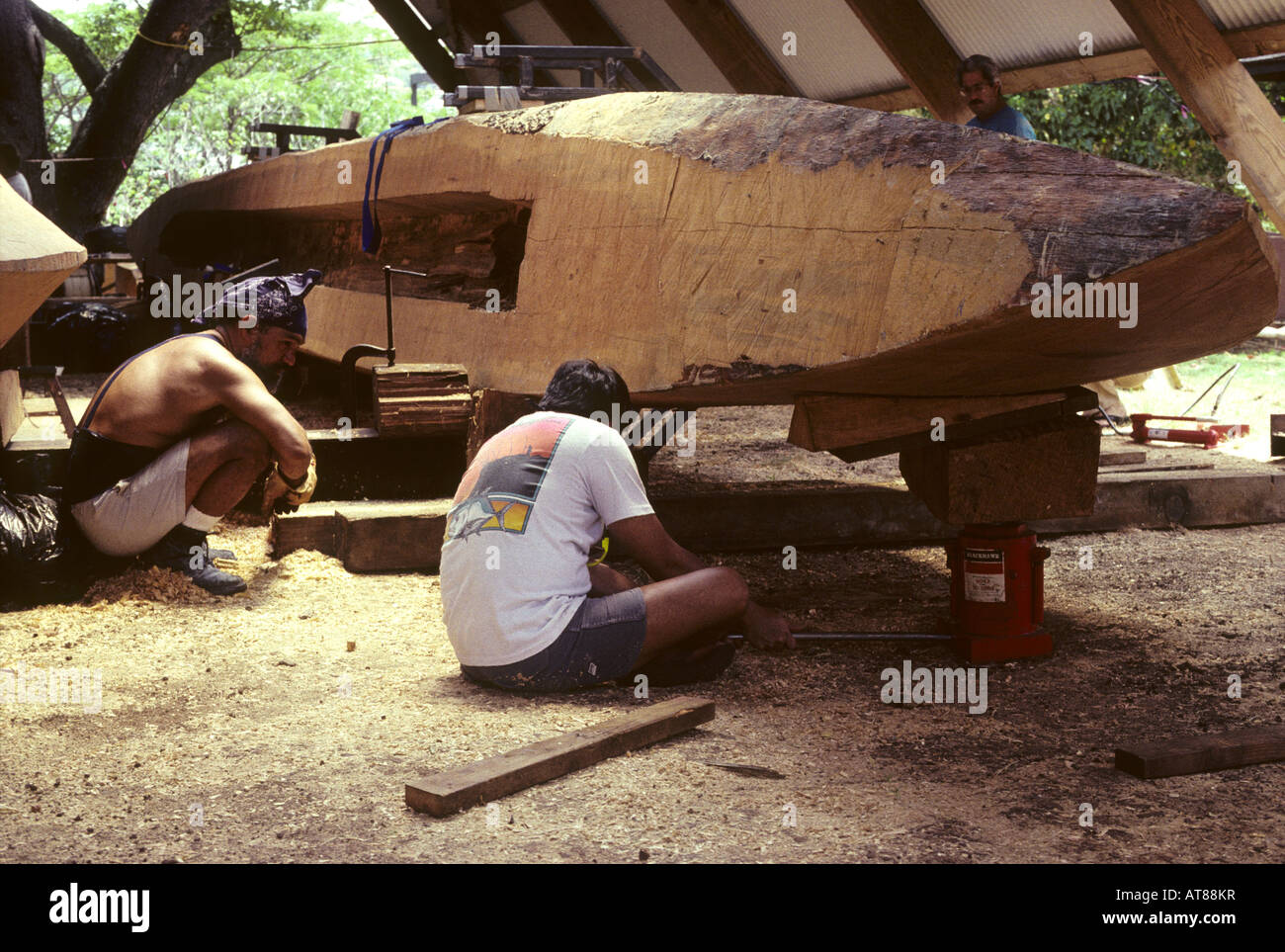 Building Polynesian voyaging canoe, Hawaiiloa carving out hull