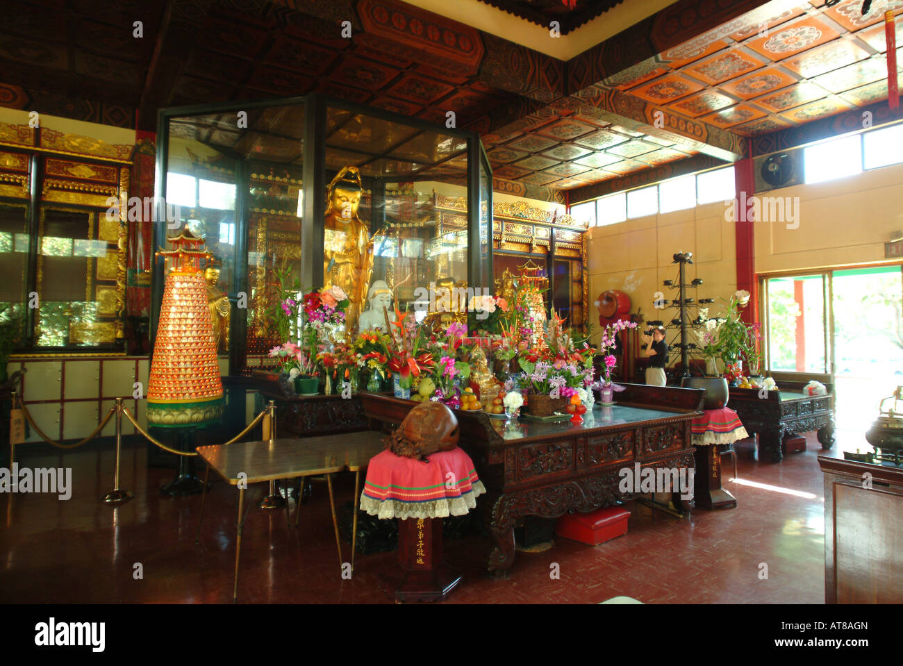 The beautiful and serene golden interior of the Kwan Yin Buddhist Temple in Honolulu Stock Photo