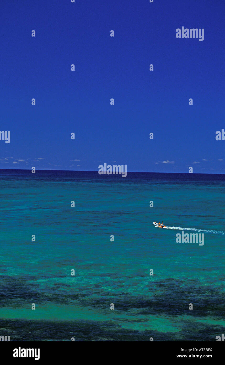 View of blue sky & ocean with small boat on right side in waters off Lanikai. Stock Photo