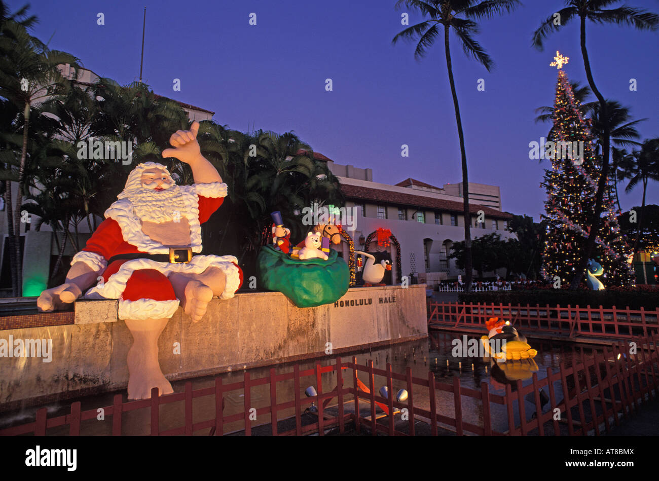 Twilight view of Hawaiian Santa & Christmas tree at Honolulu Hale Stock
