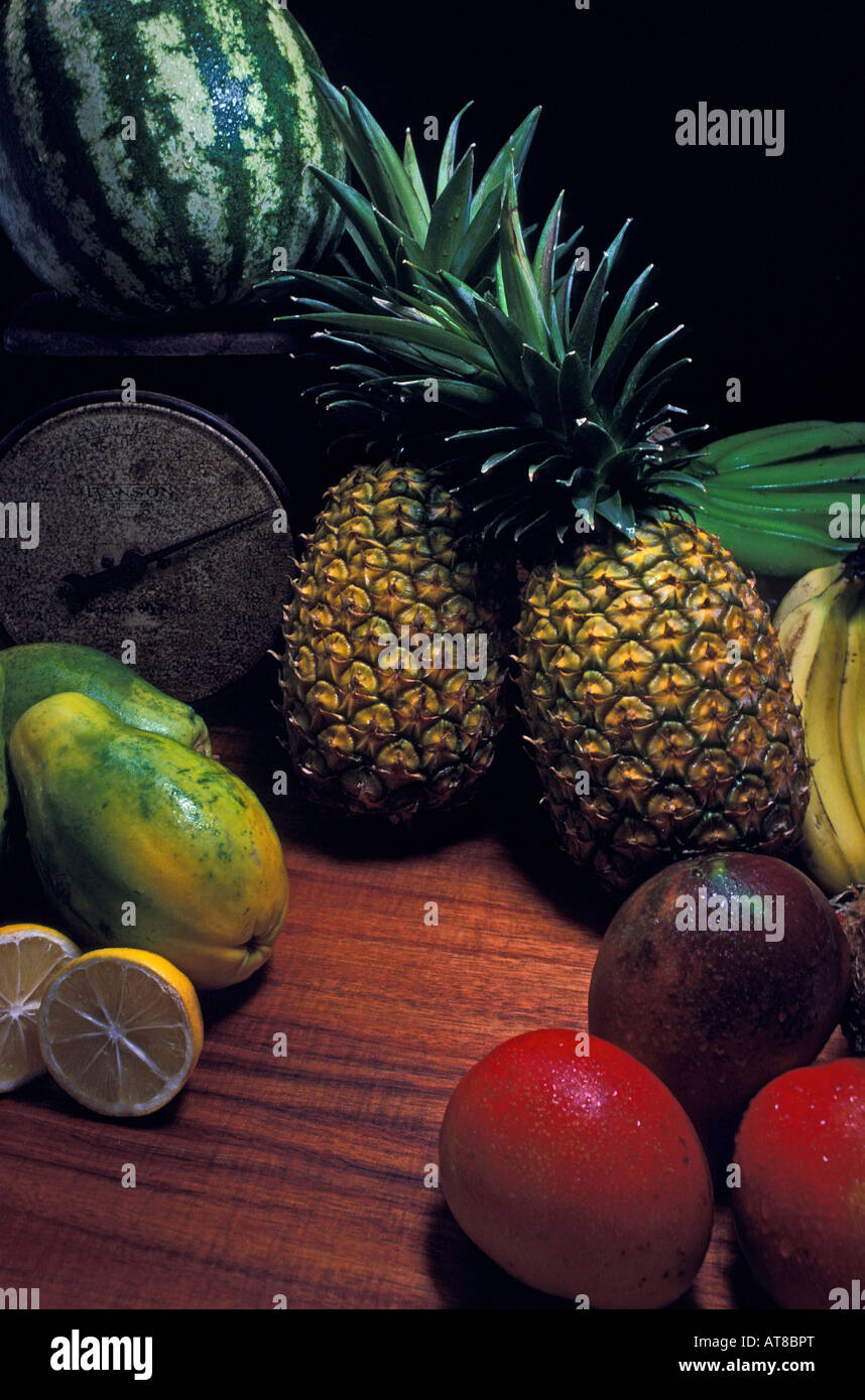 A close-up of a grouping of tropical fruits on a koa wood table Stock ...