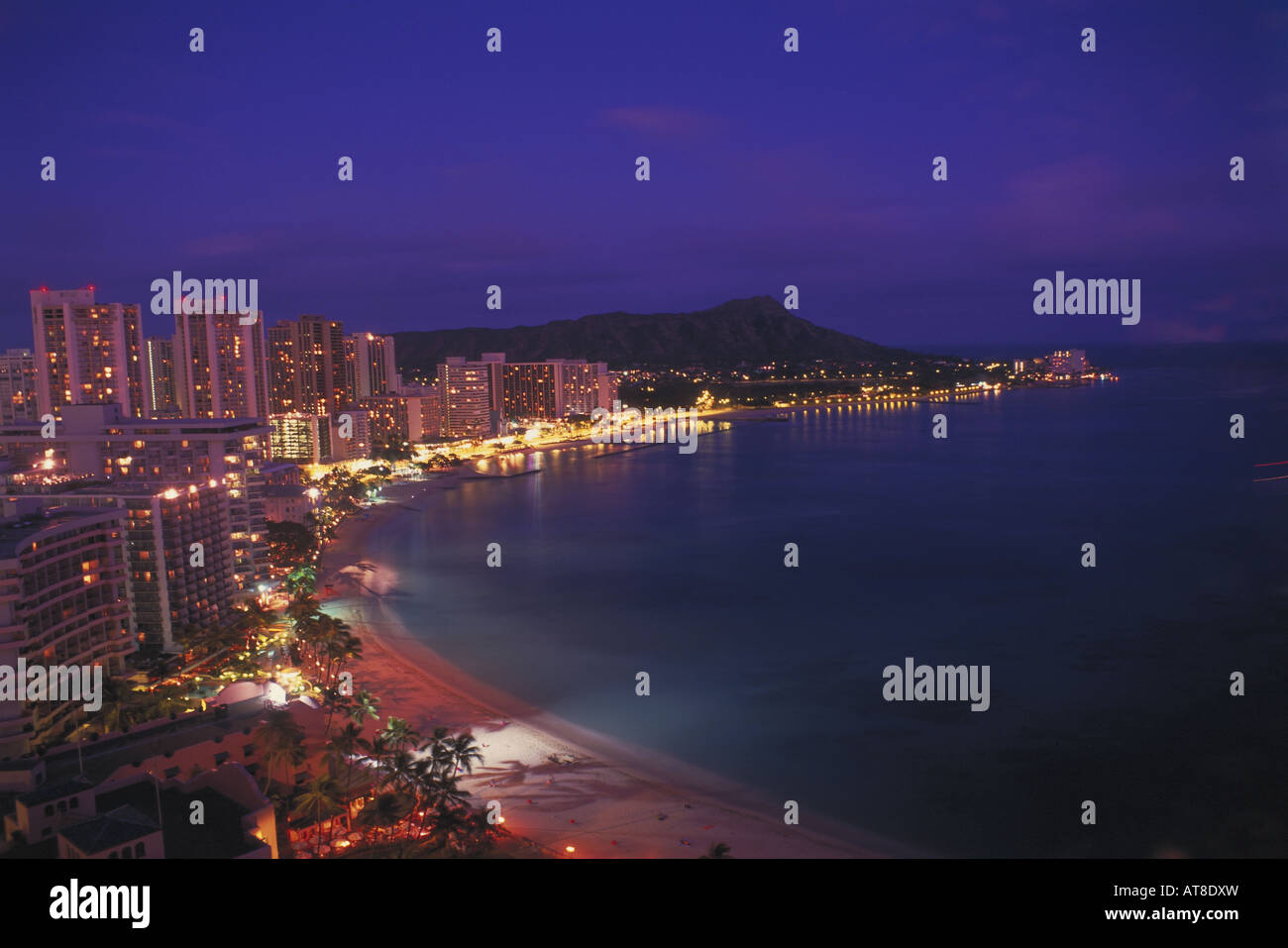 View of Waikiki Beach with Diamond head and hotels at dusk, Oahu Stock ...