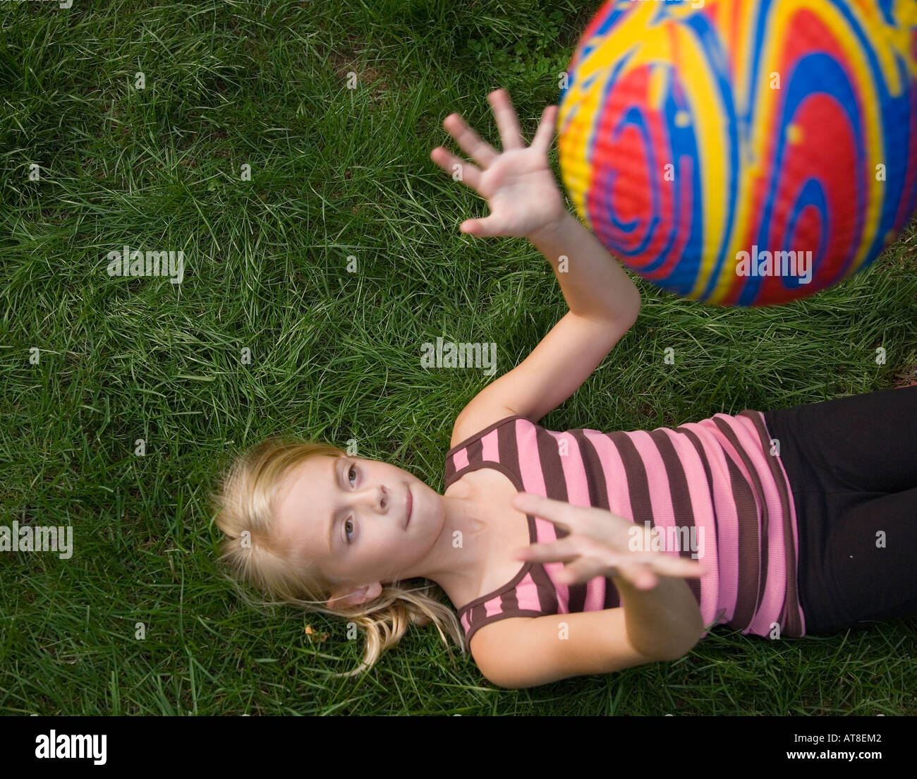 Child tossing a ball into the air Stock Photo Alamy