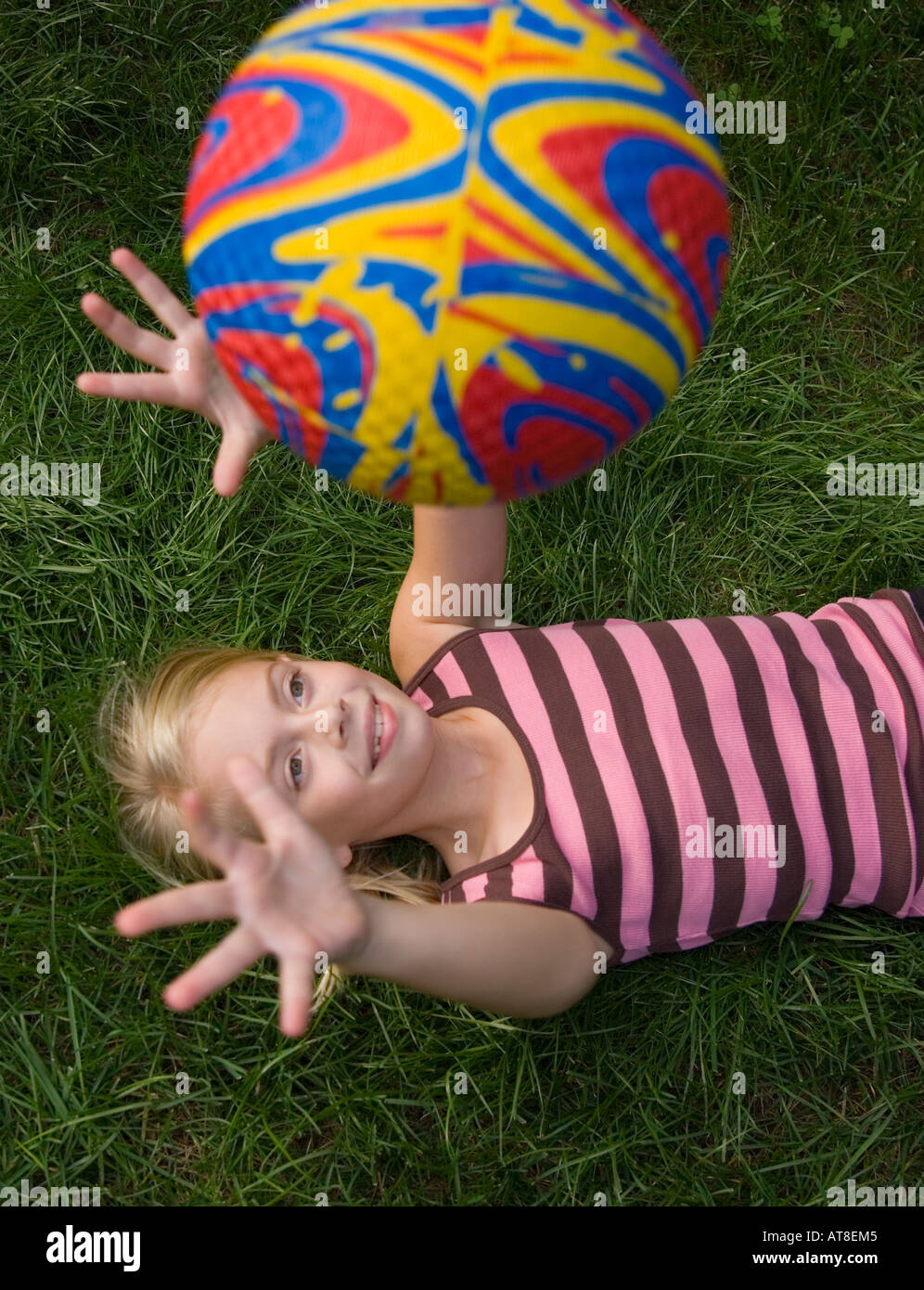 Child tossing a ball into the air Stock Photo Alamy