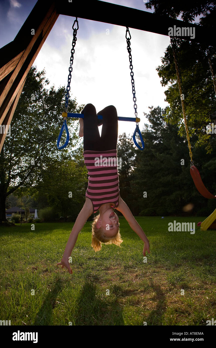Child swinging upside down Stock Photo