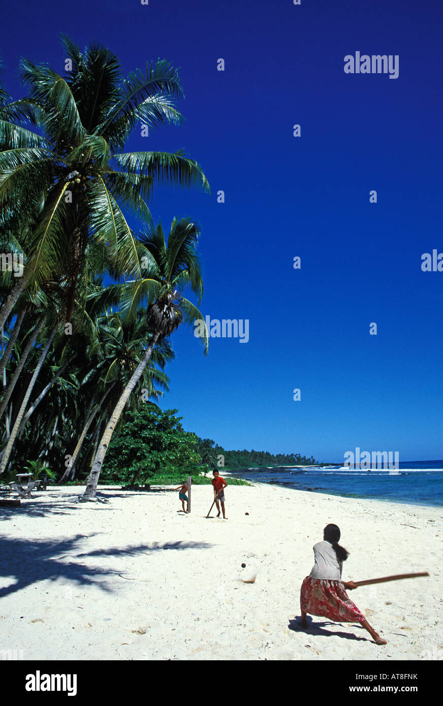 Kids play cricket on beach. Savaii, Western Samoa Stock Photo