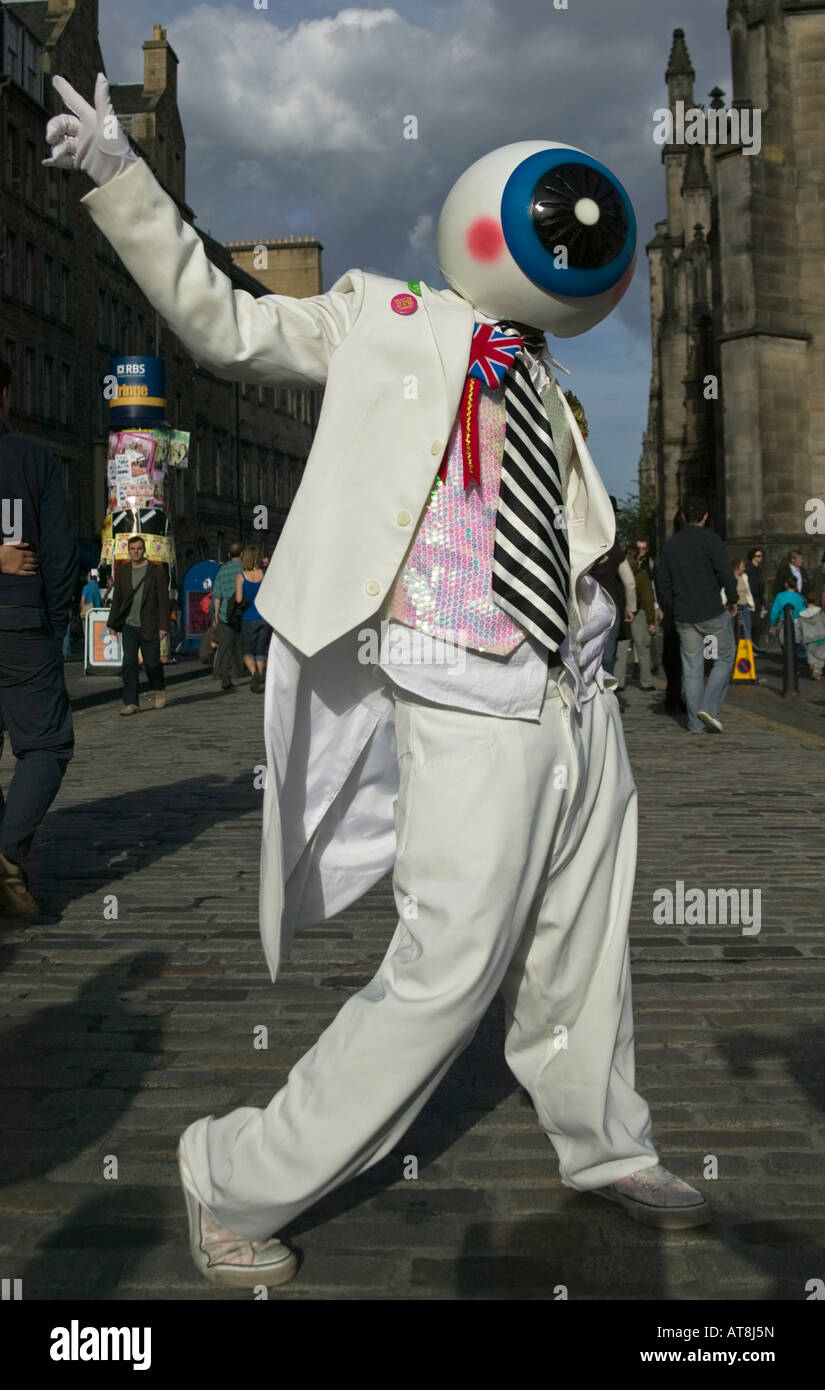Performer at Edinburgh Fringe Festival, Scotland UK, Europe, dressed in white suit with eyeball mask on head Stock Photo