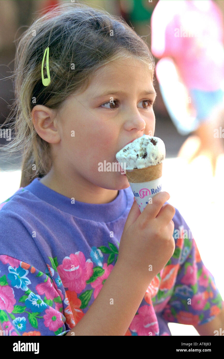 Girl age 5 eating Oreo cookie ice cream cone at Brookfield zoo. Chicago
