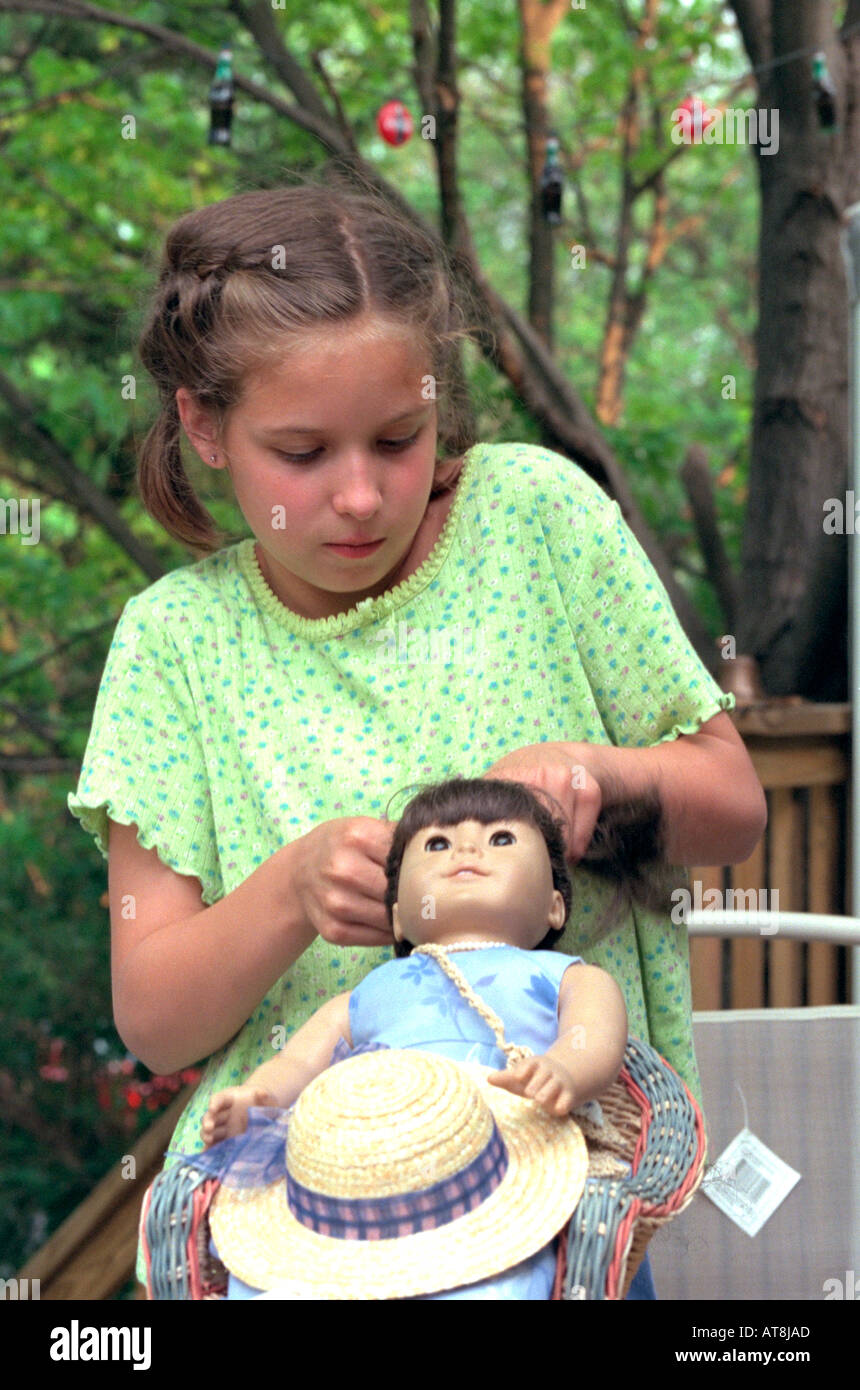 Future cosmetologist Girl age 10 braiding doll's hair. Downers Grove