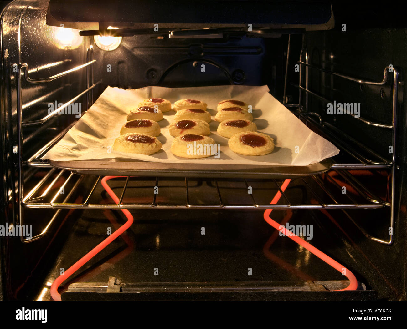 Jam Drop biscuits baking in the oven. Stock Photo