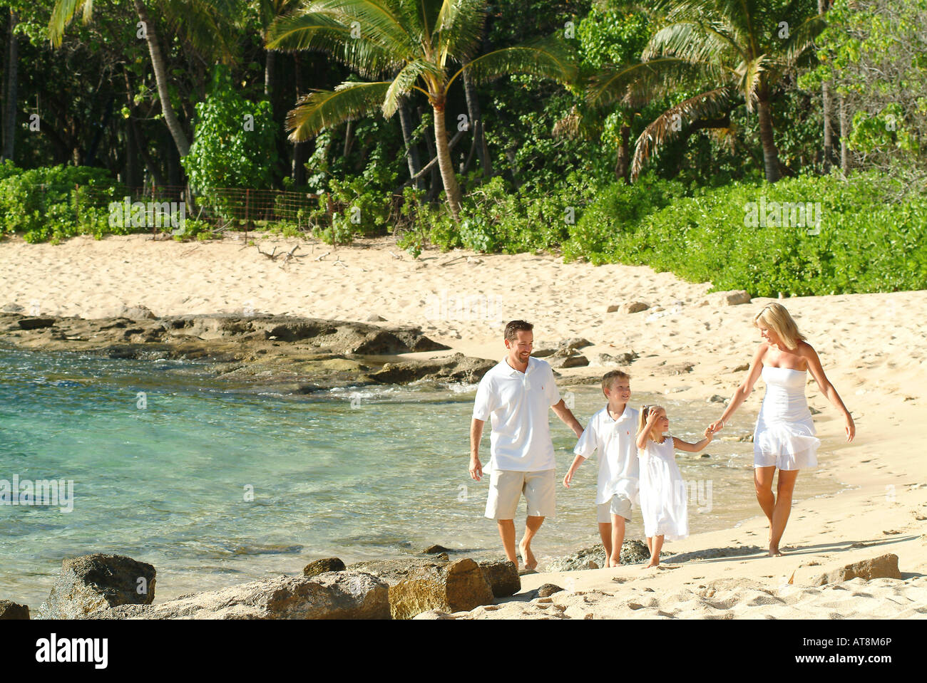 Family of four walking on beach hi-res stock photography and images - Alamy