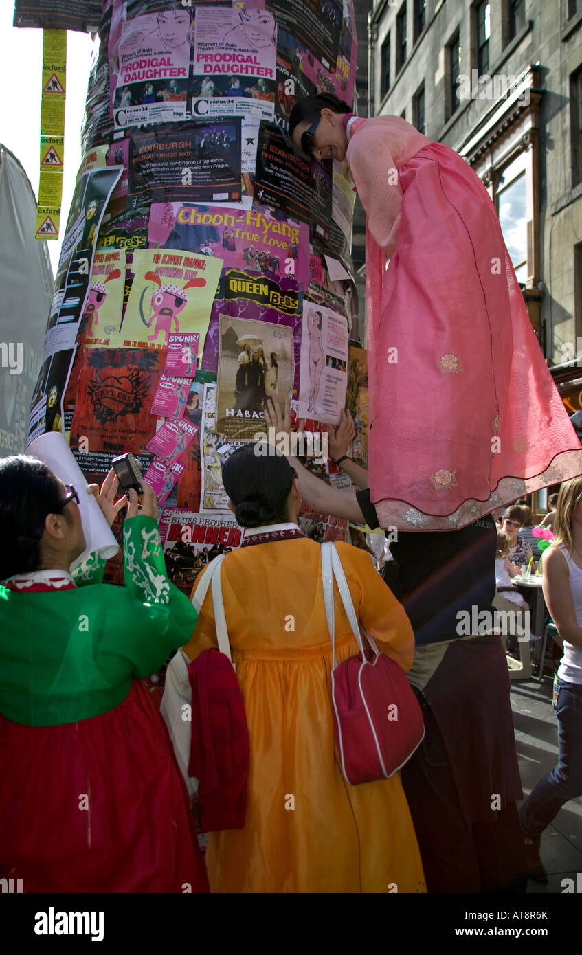 Group of performers attempt to place their poster in best spot, Edinburgh Fringe Festival, Scotland, UK, Europe Stock Photo