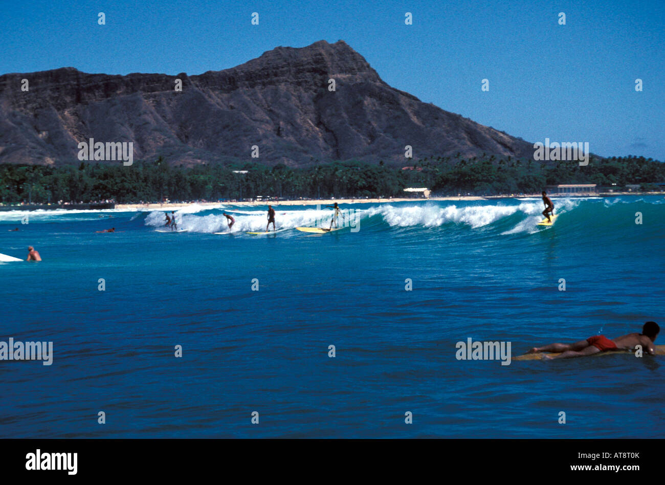 Surfing near famous Diamond head crater or Mount Leahi, Waikiki beach