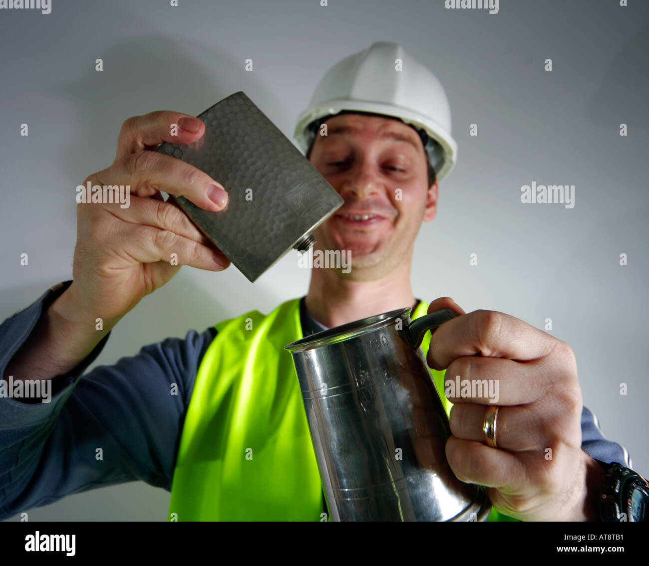 Construction worker with an alcoholic drink Stock Photo - Alamy