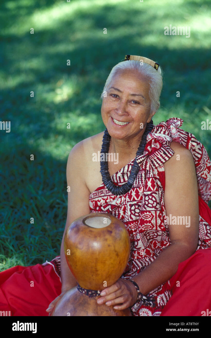 Hawaiian woman wearing kukui nut necklace seated with ipuheke gourd ...