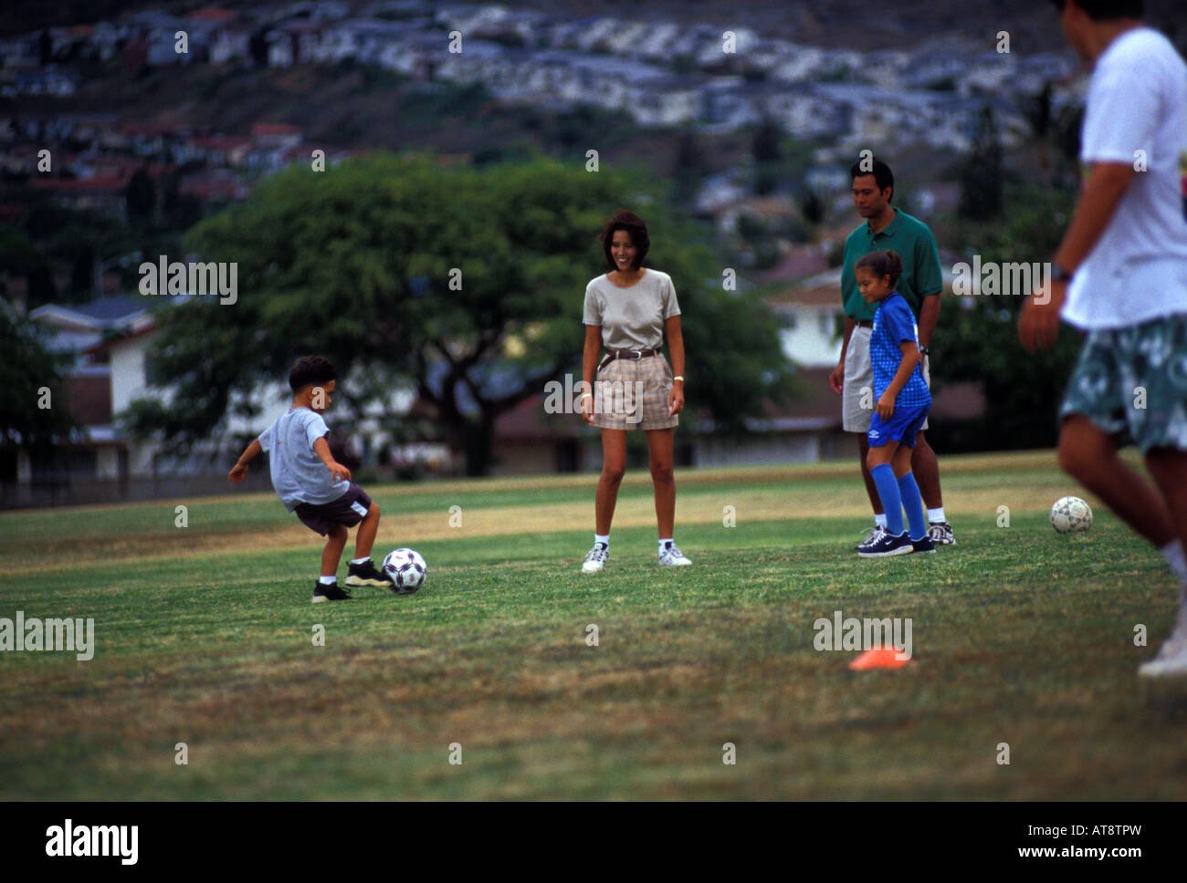 Family playing soccer at a park in Hawaii Kai, Oahu Stock Photo Alamy