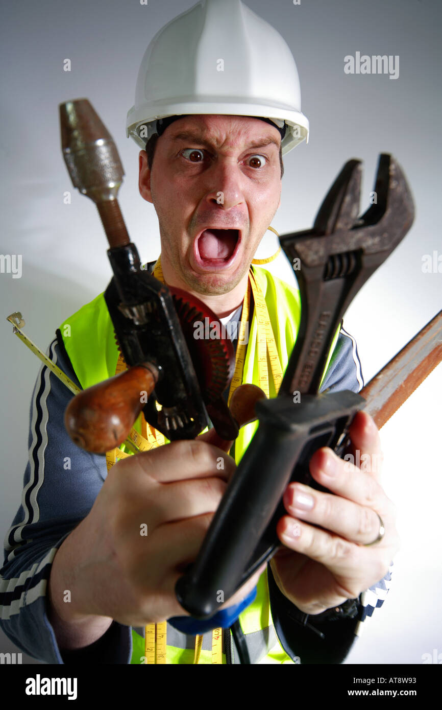 Construction worker or do it yourselfer looking shocked at tools Stock Photo
