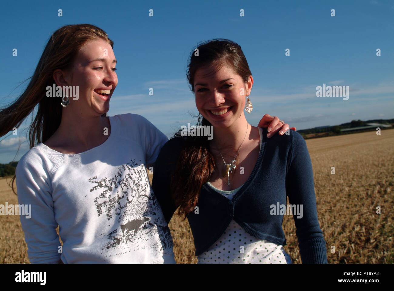 Portrait of two teenage girls with arms around each other Stock Photo ...