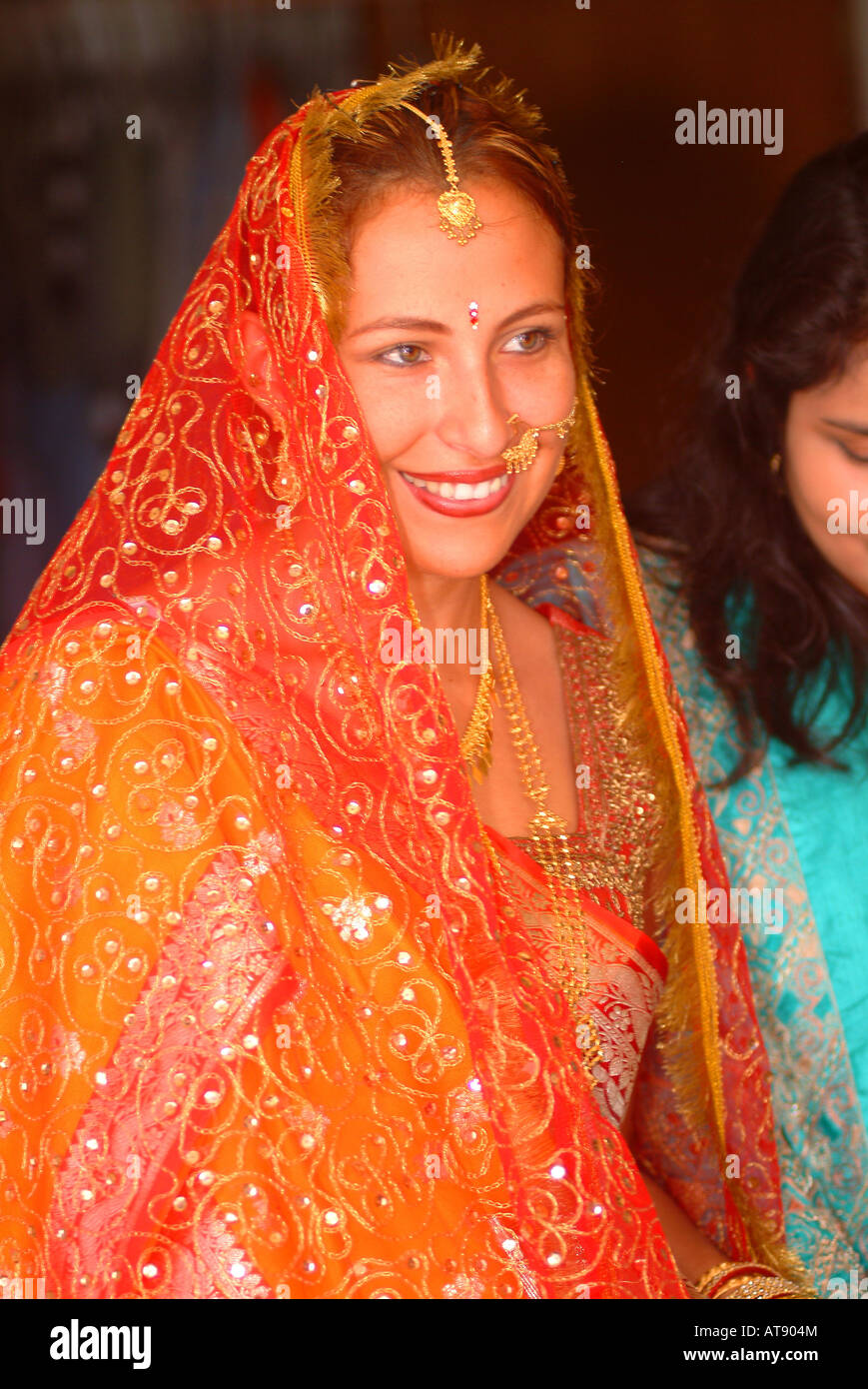 Tradditional Hindi wedding with bride with indian adornments about to 