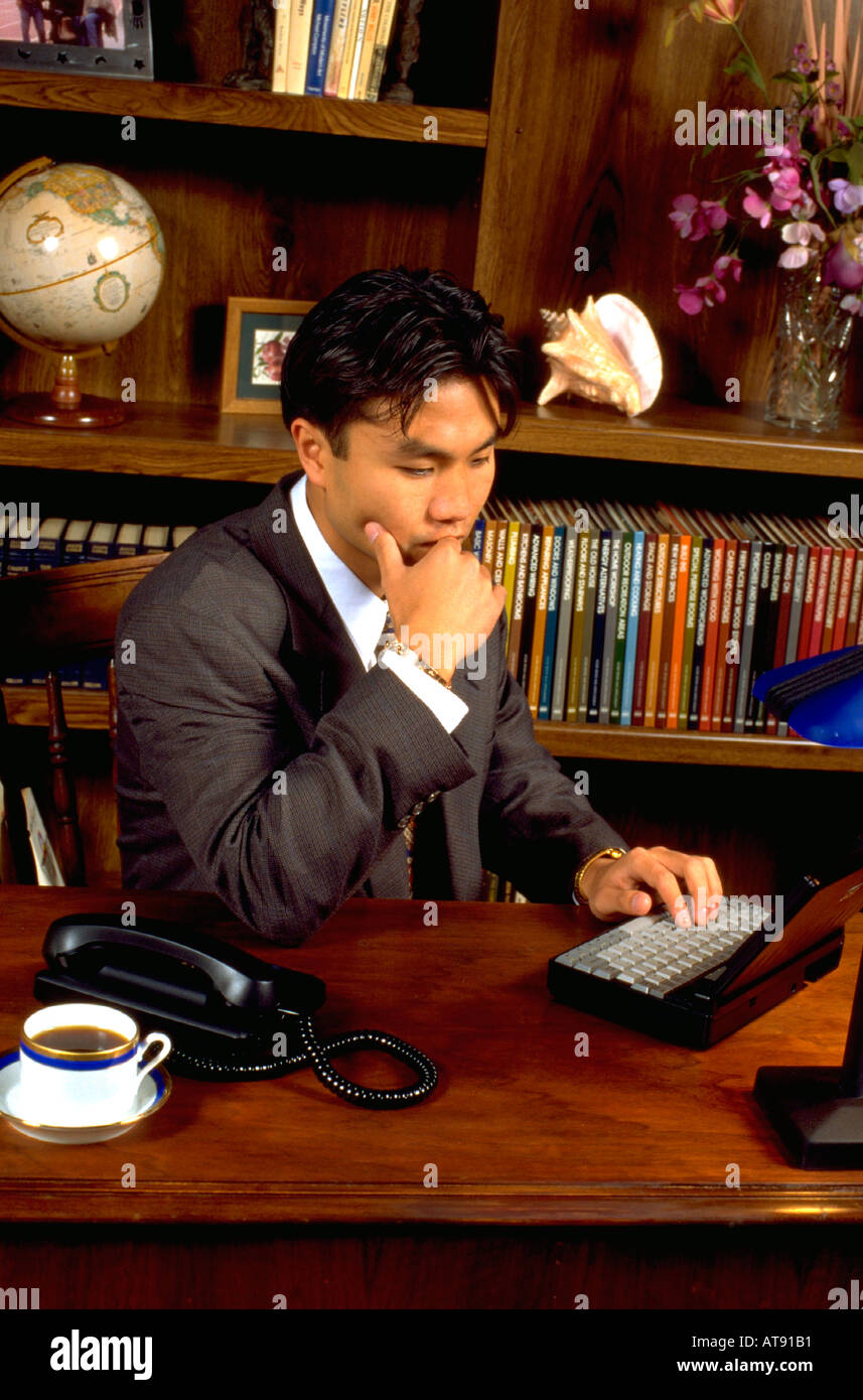 Young Korean American businessman age 24 working in office. St Paul Minnesota MN USA Stock Photo