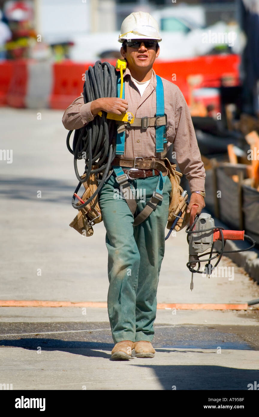 Construction workers with protective clothing and hard hats work on