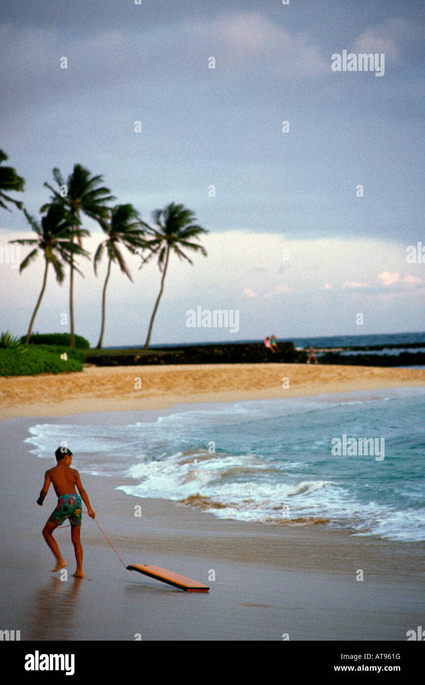 boy with boogie board at Poipu beach, Kauai Stock Photo Alamy