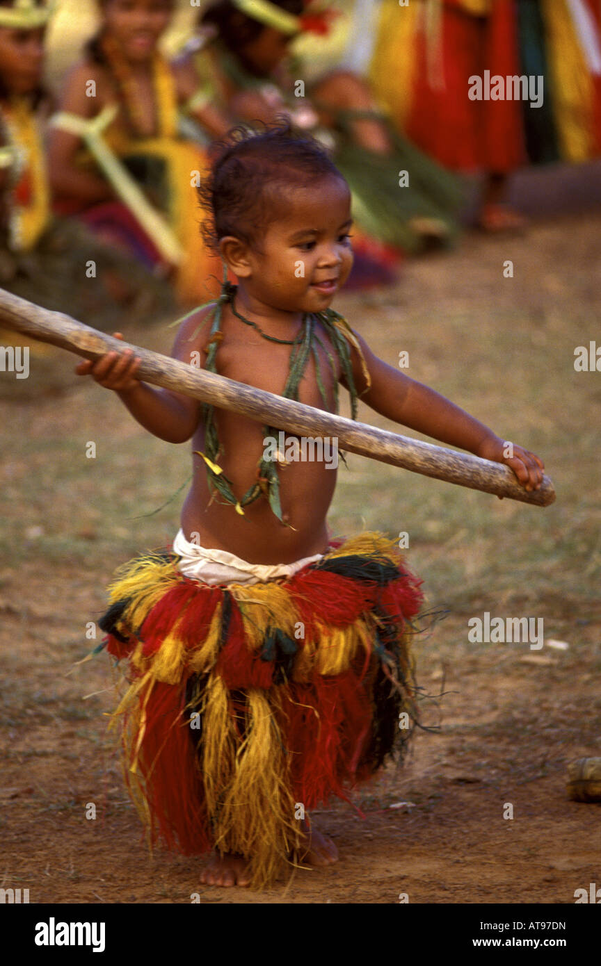 Young native girl in traditional ceremonial costume plays at performing traditional stick dance in Ma Village, Yap, Micronesia. Stock Photo
