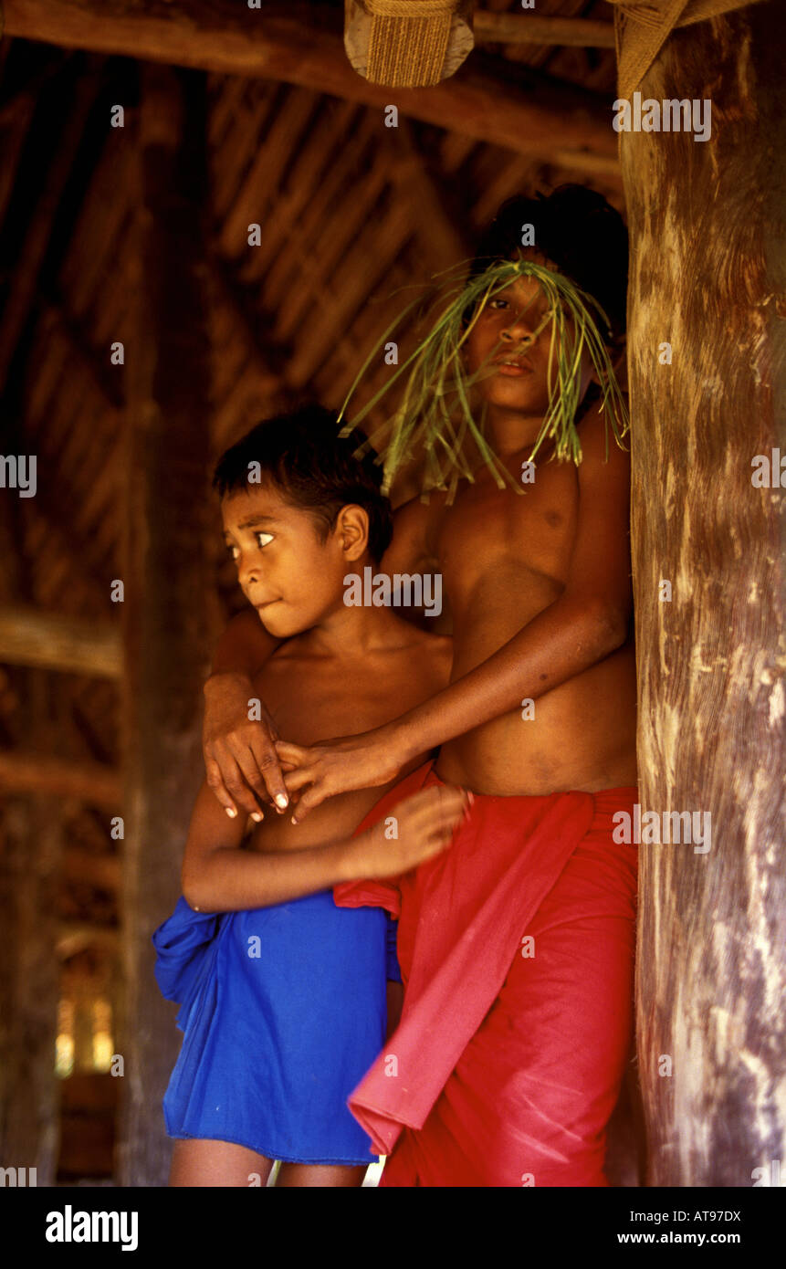 Two young native boys in traditional ceremonial costume prepare for traditional dance in a long house Ma Village Yap, Micronesia Stock Photo