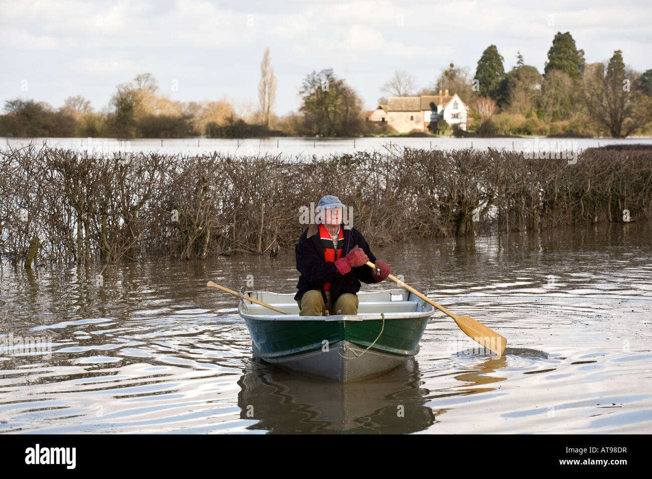 a-local-resident-travelling-by-boat-in-a-flooded-lane-near-the-river