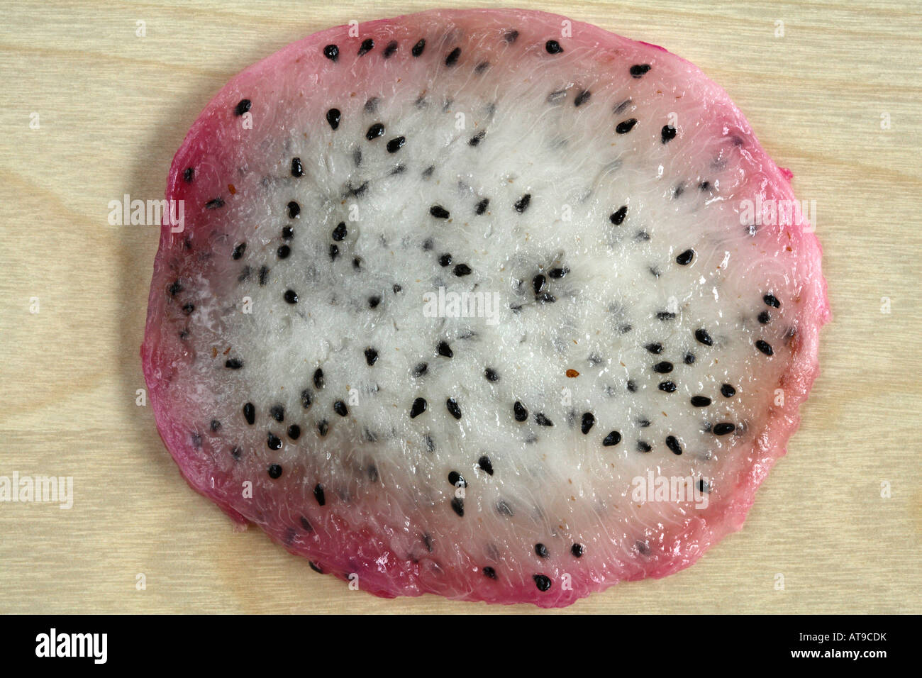 Slice Of White Fleshed Dragon Fruit Small Black Seeds In White Flesh With Swirls Of Brighter White Strands And Pinkish Edge Stock Photo Alamy