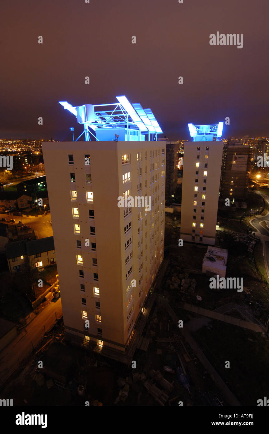 High rise flats on Manchester Road Bradford with wind turbine and lit