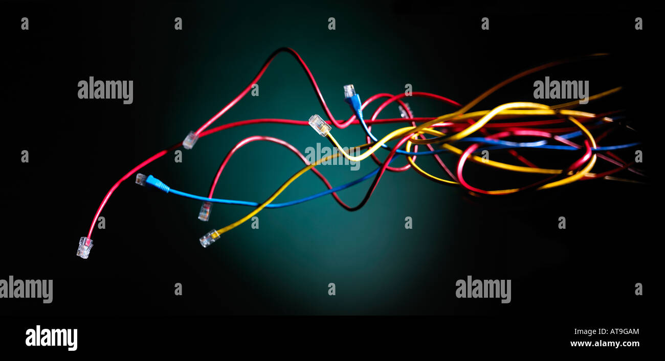 ethernet cables hovering floating across a black green background Stock Photo