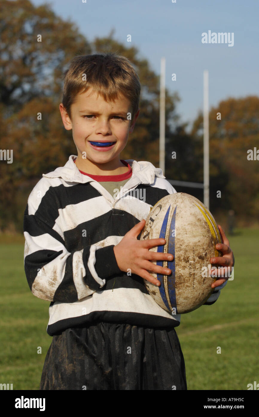 Young boy lad rugby player with rugby ball and gum guard Stock Photo