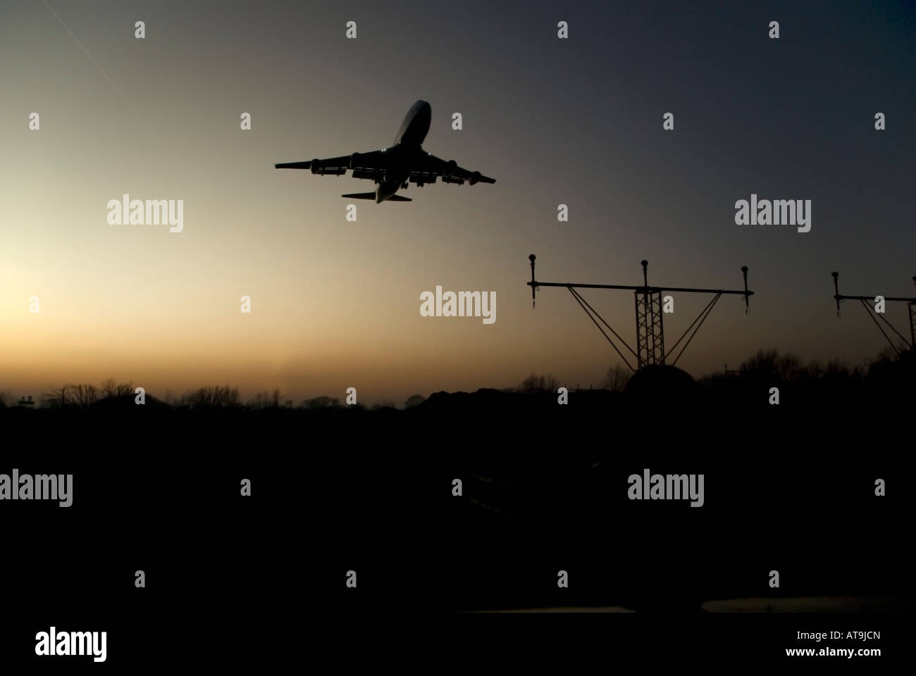 Aircraft on final approach to Heathrow airport, London at dusk Stock ...