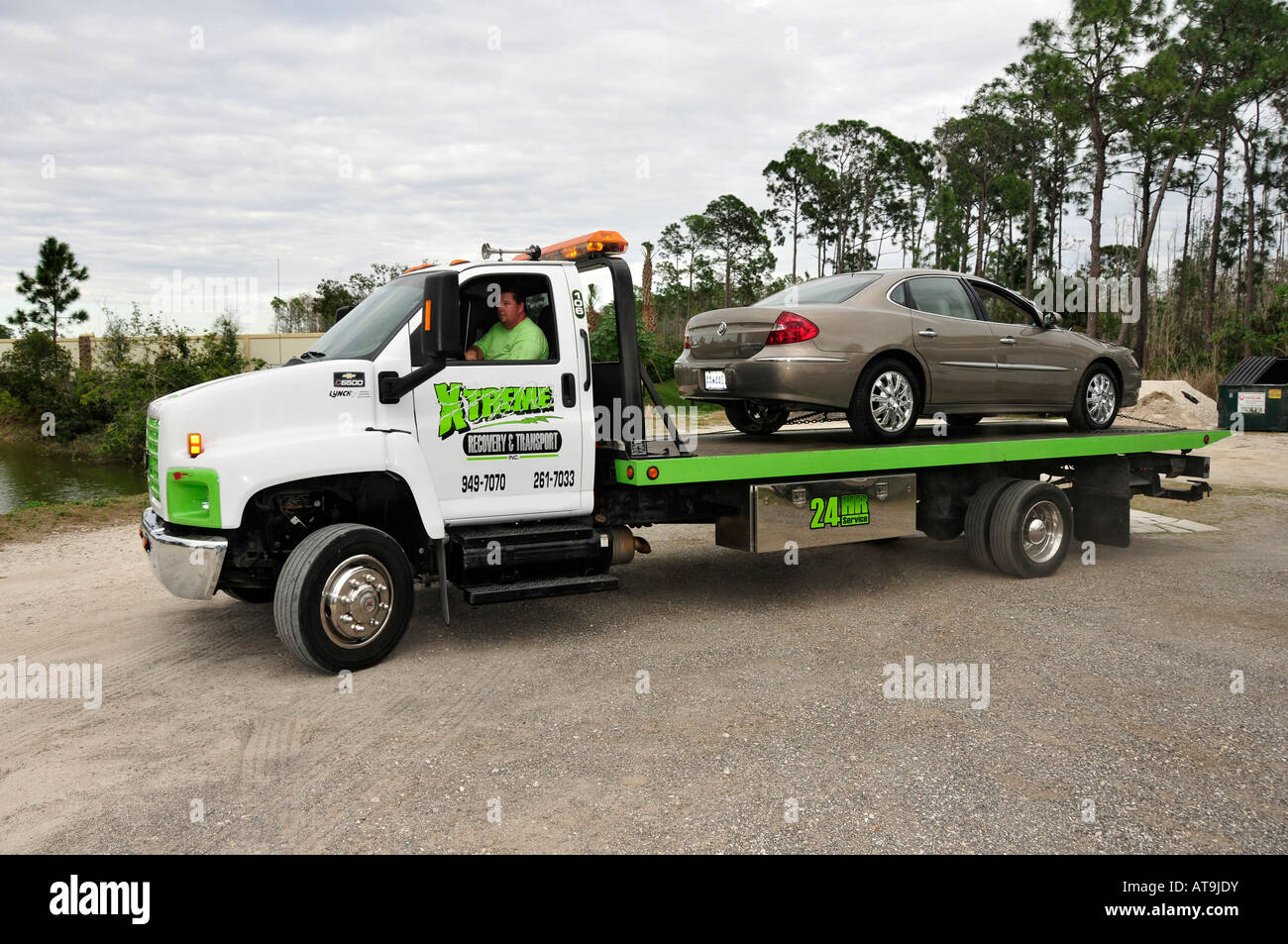Tow truck clears accident scene of automobile Stock Photo