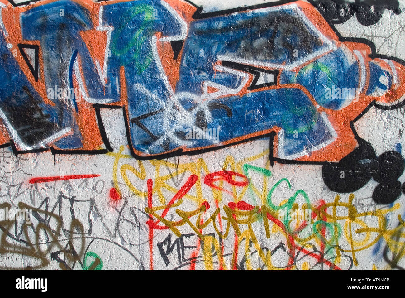 Colourful graffiti and barbed wire from Thames Path. North Greenwich, London, England Stock Photo