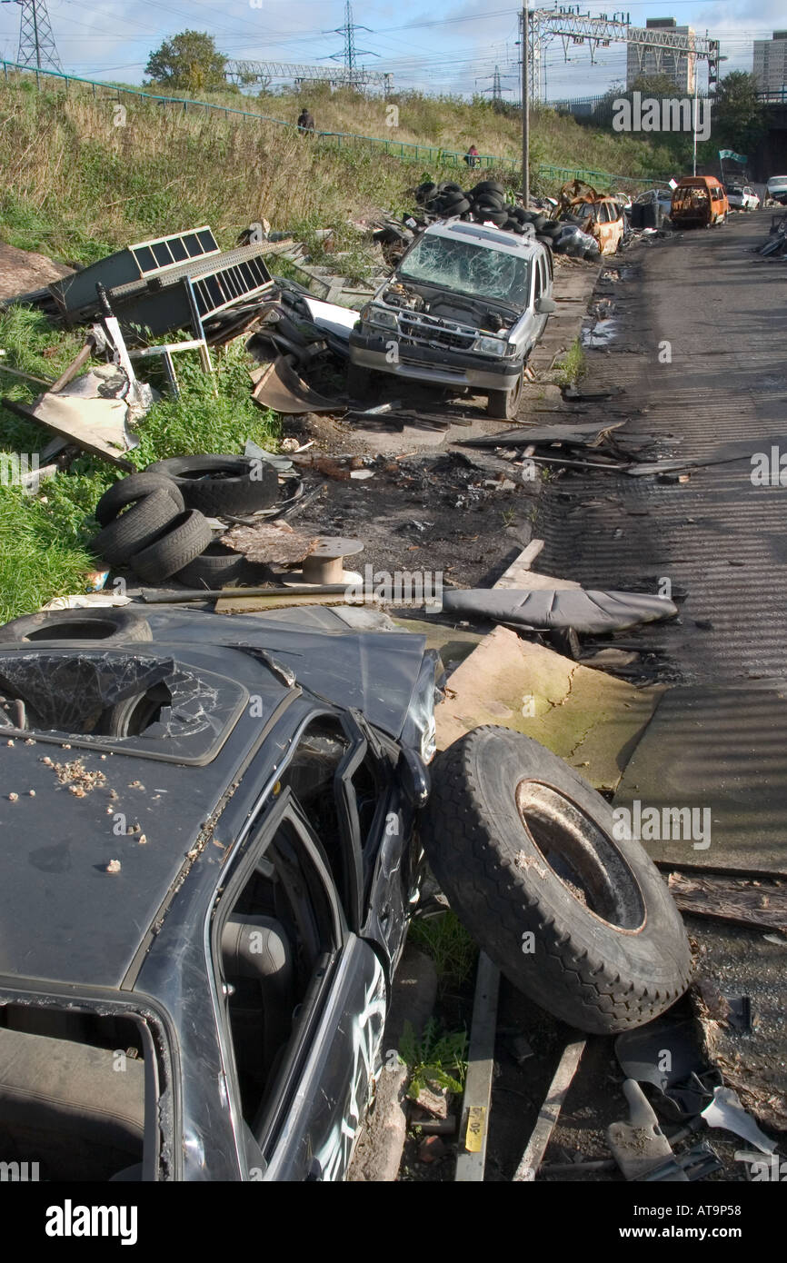 Abandoned wrecked cars and rubbish. Marshgate Lane, Stratford, London, England Stock Photo