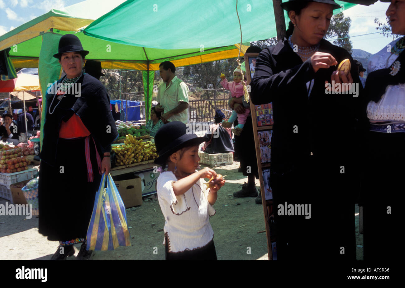 Colourful Sunday market in Saraguro with people shopping and eating Stock Photo