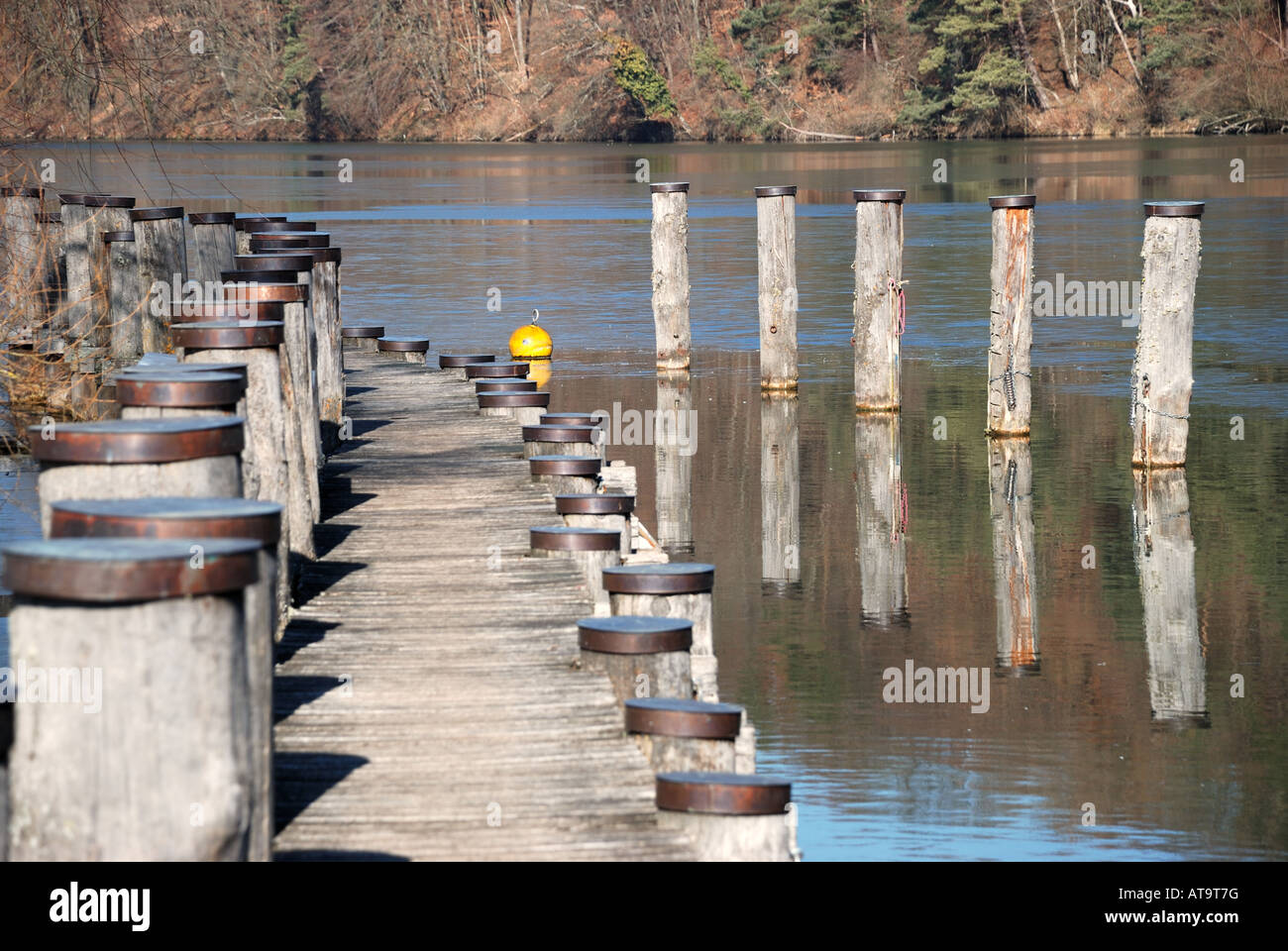 wooden landing stage with poles for boats Stock Photo Alamy