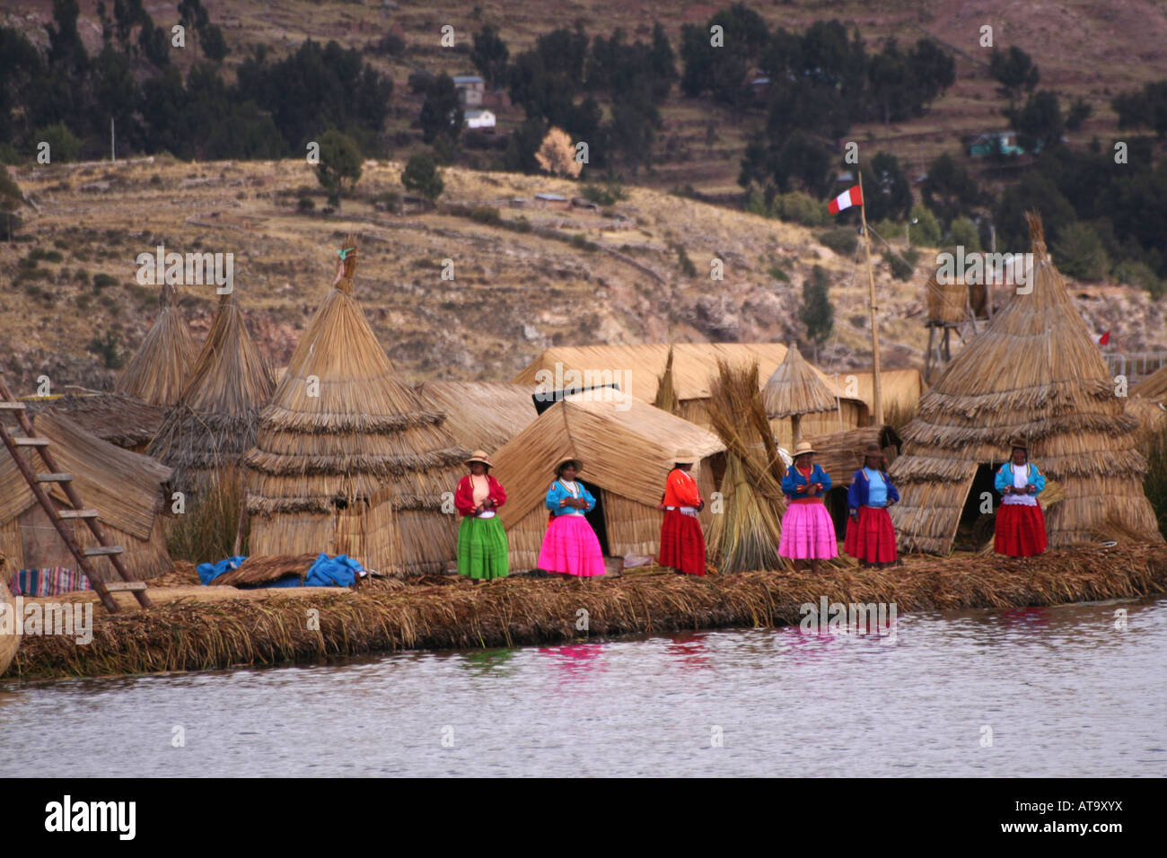 Villagers at Uros floating reed village Lake Titicaca Peru Stock Photo