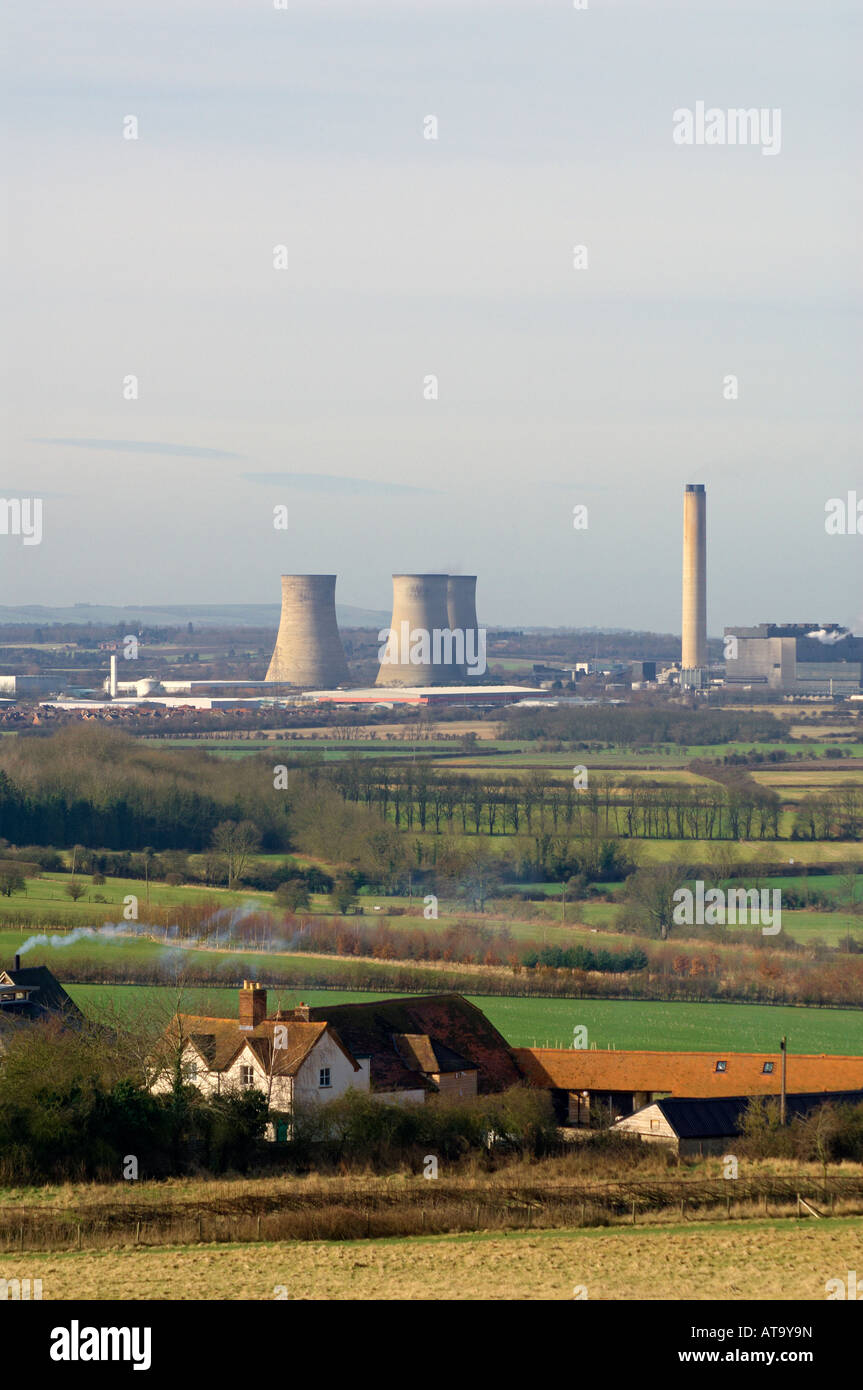 Didcot Power Station, Oxfordshire, with smoke coming from a domestic chimney in the foreground. Stock Photo