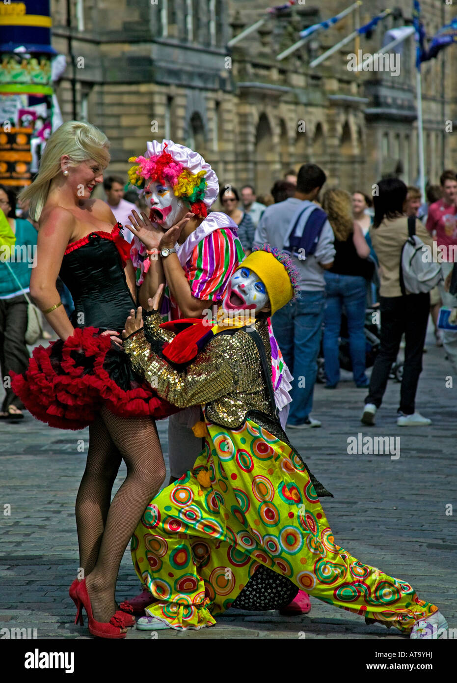 Two clowns admire a blonde opera singer street performer in a showgirl outfit, Edinburgh Fringe Festival, Scotland, UK, Europe Stock Photo