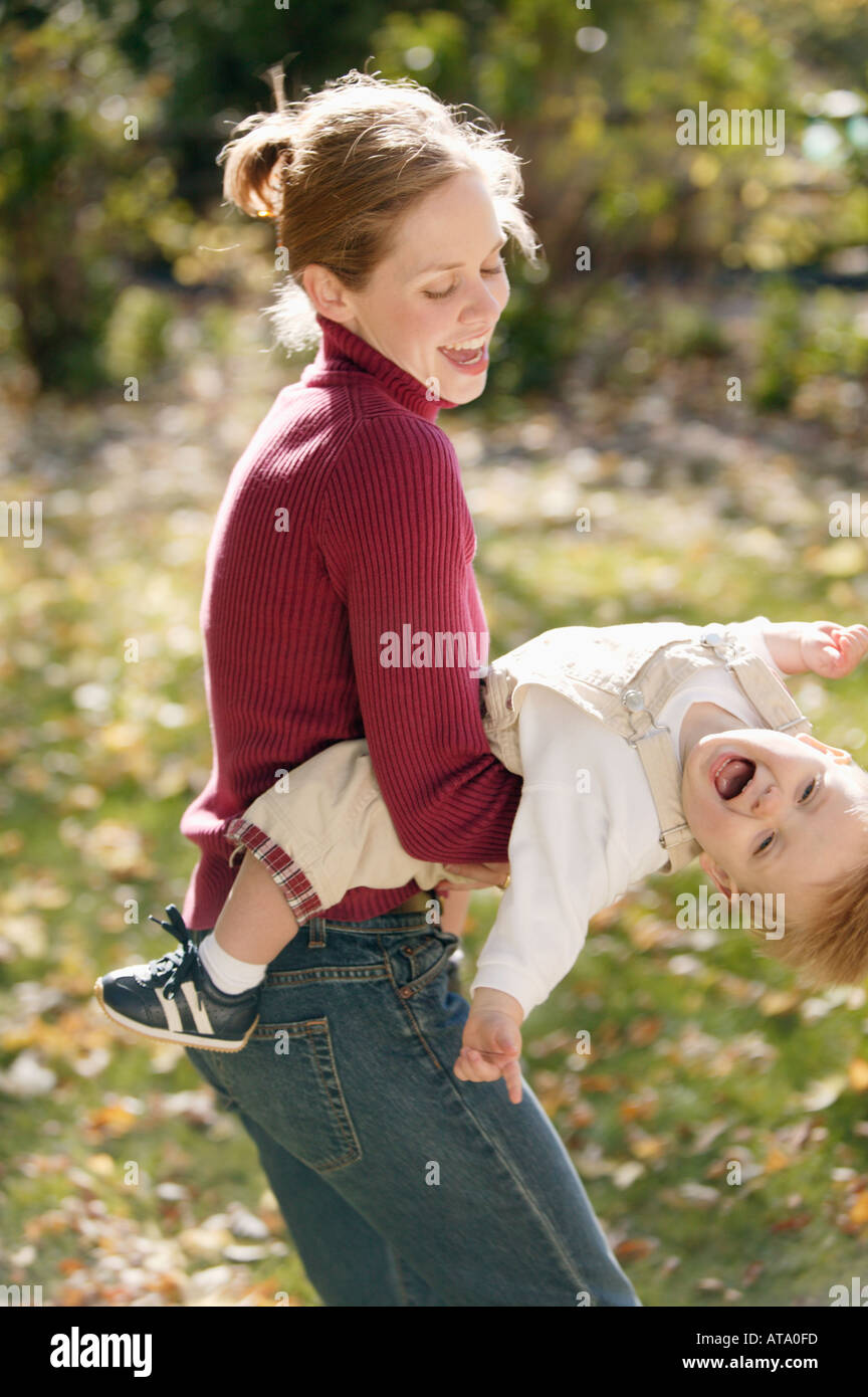 Mother playfully swings son Stock Photo