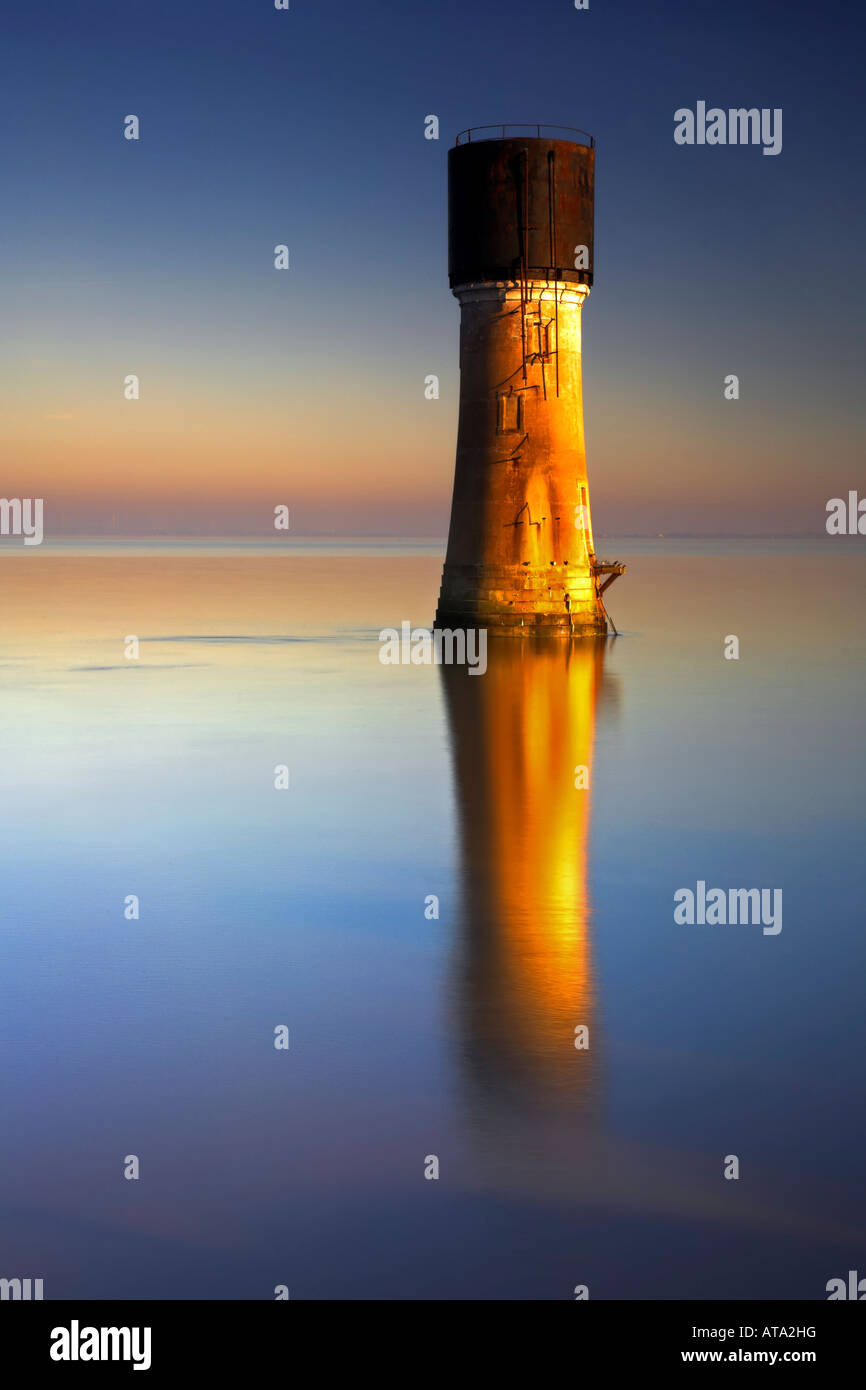The Old Spurn Point Lighthouse and its reflection in the Humber Estuary on the Holderness Coast Humberside East Yorkshire UK Stock Photo